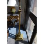 A brass corinthian column style floor standing lamp.