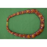A large amber style necklace.