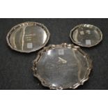 Three silver salvers with engraved presentation inscriptions.