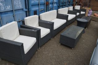 A modern nine piece grey rattan style outdoor lounge suite comprising a pair of settees, set of four