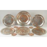 A COLLECTION OF TINNED COPPER DISHES AND COASTERS, large dish 36cm diameter, six dishes 29.5cm