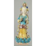 A CHINESE FAHUA-TYPE FIGURE OF GUANYIN, stood upon a lotus formed base, 22.5cm high.