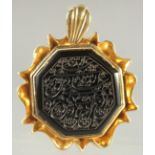 A FINE ISLAMIC CALLIGRAPHIC SEAL inset within a gilt metal pendant, 3.5cm x 3.5cm.