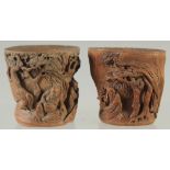 A SMALL PAIR OF CHINESE CARVED BAMBOO CUPS, relief carved with figures in a woodland scene, 5.5cm