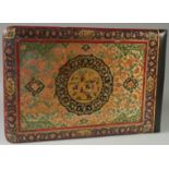 A LARGE QAJAR PAINTED WOODEN ALBUM COVER, the front and verso with central circular panel; one