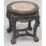 A GOOD CHINESE MARBLE INSET CARVED HARDWOOD STAND, with petal-form top and carved frieze, on four