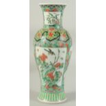 A CHINESE FAMILLE VERTE PORCELAIN VASE, painted with panels of flora, 30cm high.
