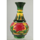 A CHINESE YELLOW, RED AND GREEN PEKING GLASS VASE, with raised flower heads and vine, 24cm high.