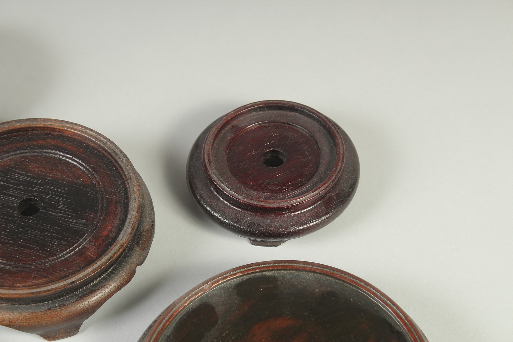 A COLLECTION OF EIGHT CHINESE HARDWOOD STANDS, various sizes, largest 17.5cm diameter. - Image 7 of 7