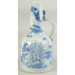 A JAPANESE ARITA BLUE AND WHITE PORCELAIN JUG, painted with landscape and with dragon formed handle,