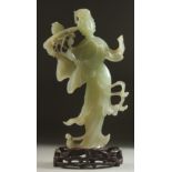 A CHINESE CARVED JADE FIGURE OF GUANYIN on a fitted wooden base, figure 24.5cm high.