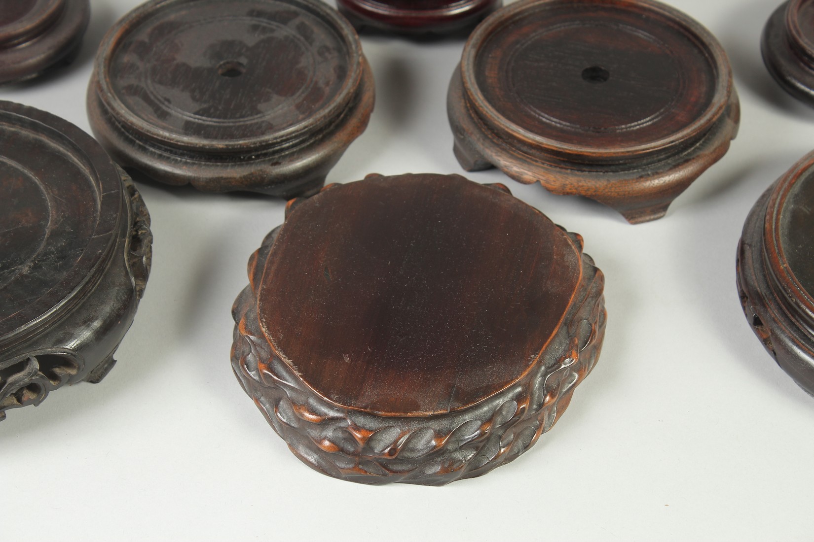 A COLLECTION OF EIGHT CHINESE HARDWOOD STANDS, various sizes, largest 17.5cm diameter. - Image 3 of 7