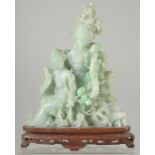 A CHINESE CARVED JADEITE FIGURAL GROUP on hardwood stand, 25.5cm high.