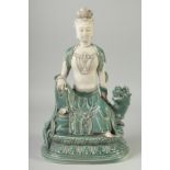 A LARGE CHINESE DEHUA GUANYIN seated upon a lion, 38cm high.