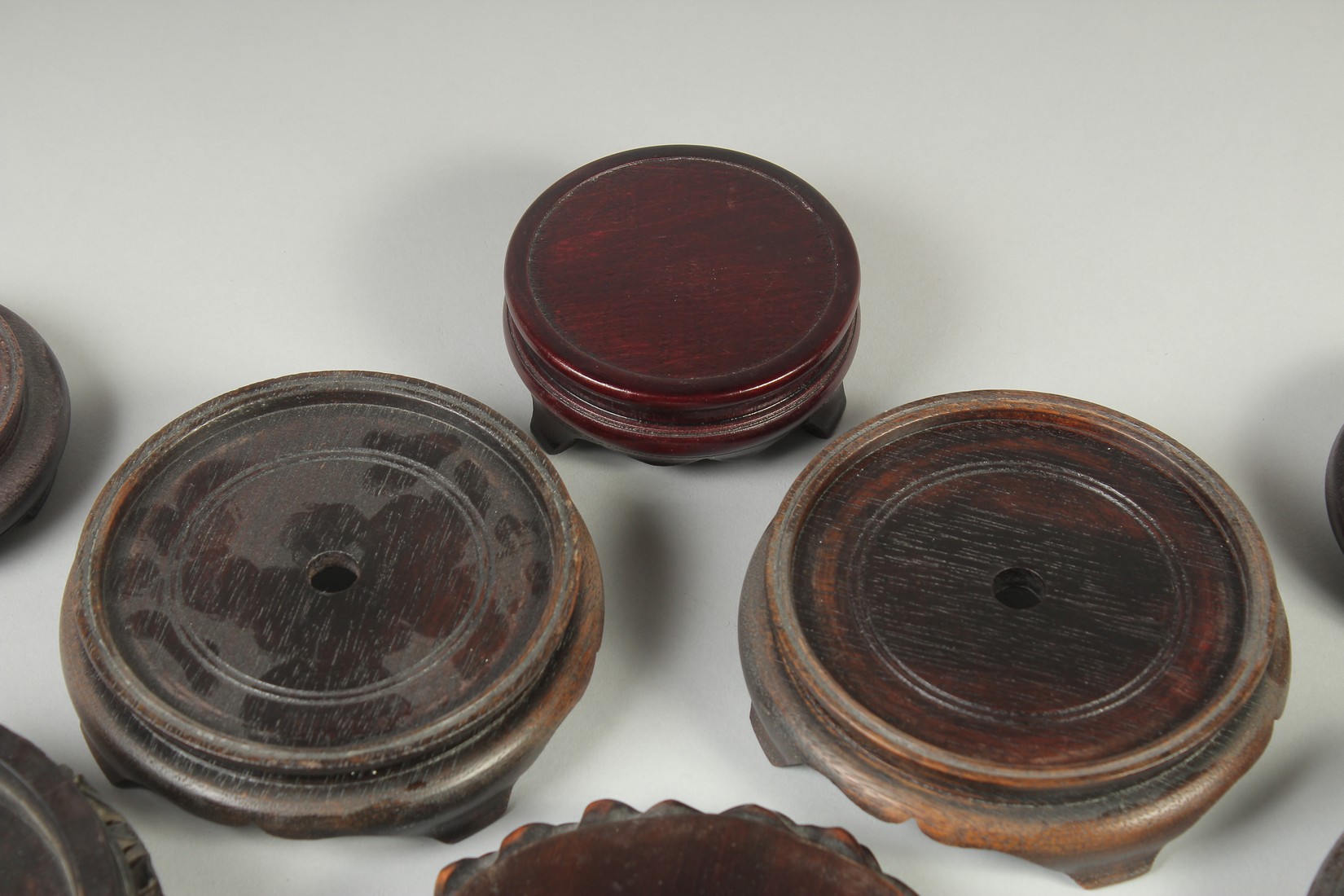 A COLLECTION OF EIGHT CHINESE HARDWOOD STANDS, various sizes, largest 17.5cm diameter. - Image 5 of 7