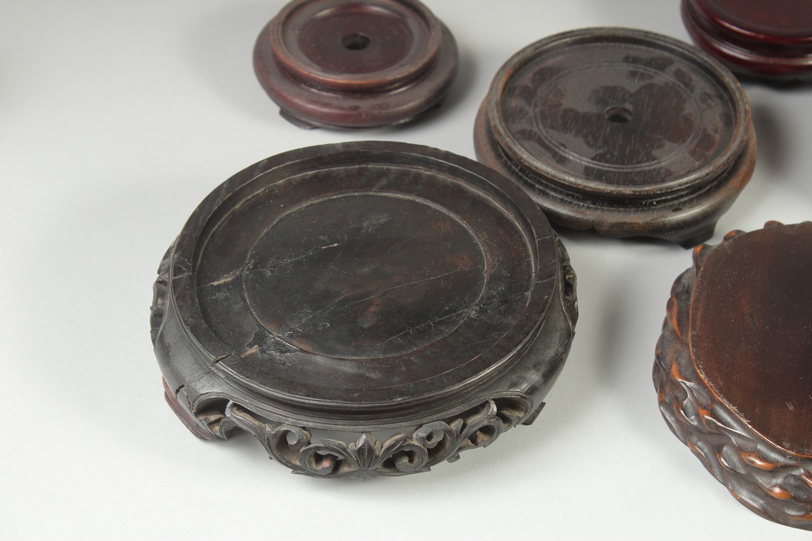 A COLLECTION OF EIGHT CHINESE HARDWOOD STANDS, various sizes, largest 17.5cm diameter. - Image 2 of 7