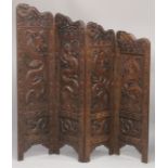 A SUPERB KASHMIRI / CHINESE CARVED FOUR PANEL SCREEN, beautifully carved with panels of dragons; the