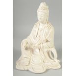 A LARGE CHINESE BLANC-DE-CHINE FIGURE OF SEATED GUANYIN, holding a ruyi scepter, 28cm high.