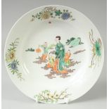 A CHINESE FAMILLE VERTE PORCELAIN PLATE, painted with a female and boys, red six-character mark to