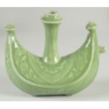 A CHINESE OTTOMAN MARKET GREEN GLAZE WATER POT, with floral decoration, 19cm long.