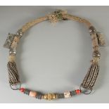 AN ISLAMIC SILVER, GILT METAL AND HARDSTONE MARRIAGE NECKLACE.