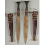 TWO DAGGERS IN LEATHER SHEATHS, (2).