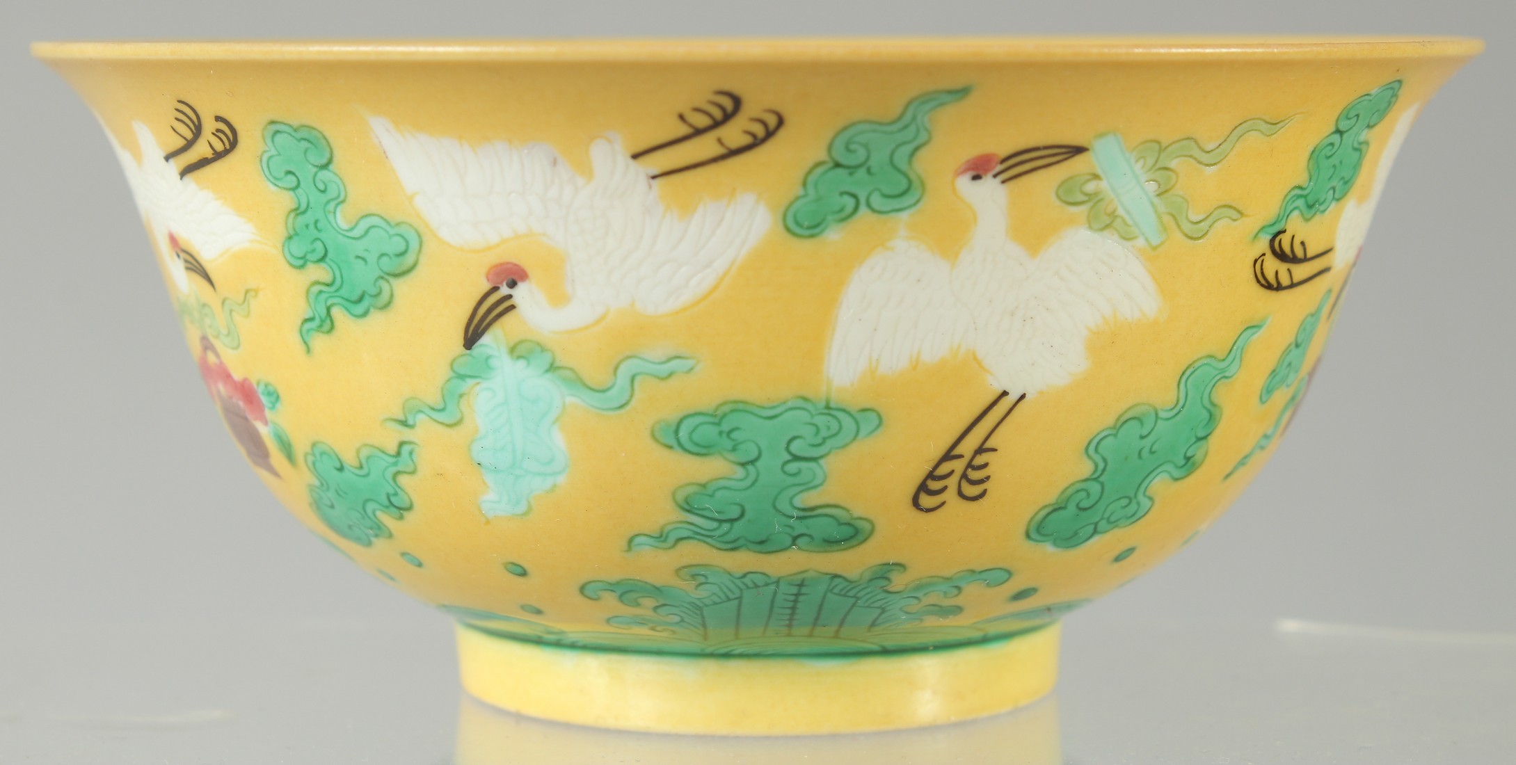 A CHINESE YELLOW GROUND ENAMELLED CRANE BOWL, with longevity symbol to interior and character mark