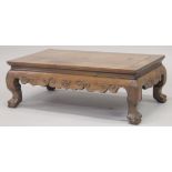 A 19TH CENTURY CHINESE KANG TABLE, with carved frieze on cabriole legs terminating in claw feet,