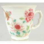 A 19TH CENTURY CHINESE FAMILLE ROSE PORCELAIN TEACUP, painted with a bird and flora, 6cm high.