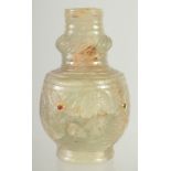 A FINE CARVED JADE BOTTLE, inset with small stones, 9cm high.