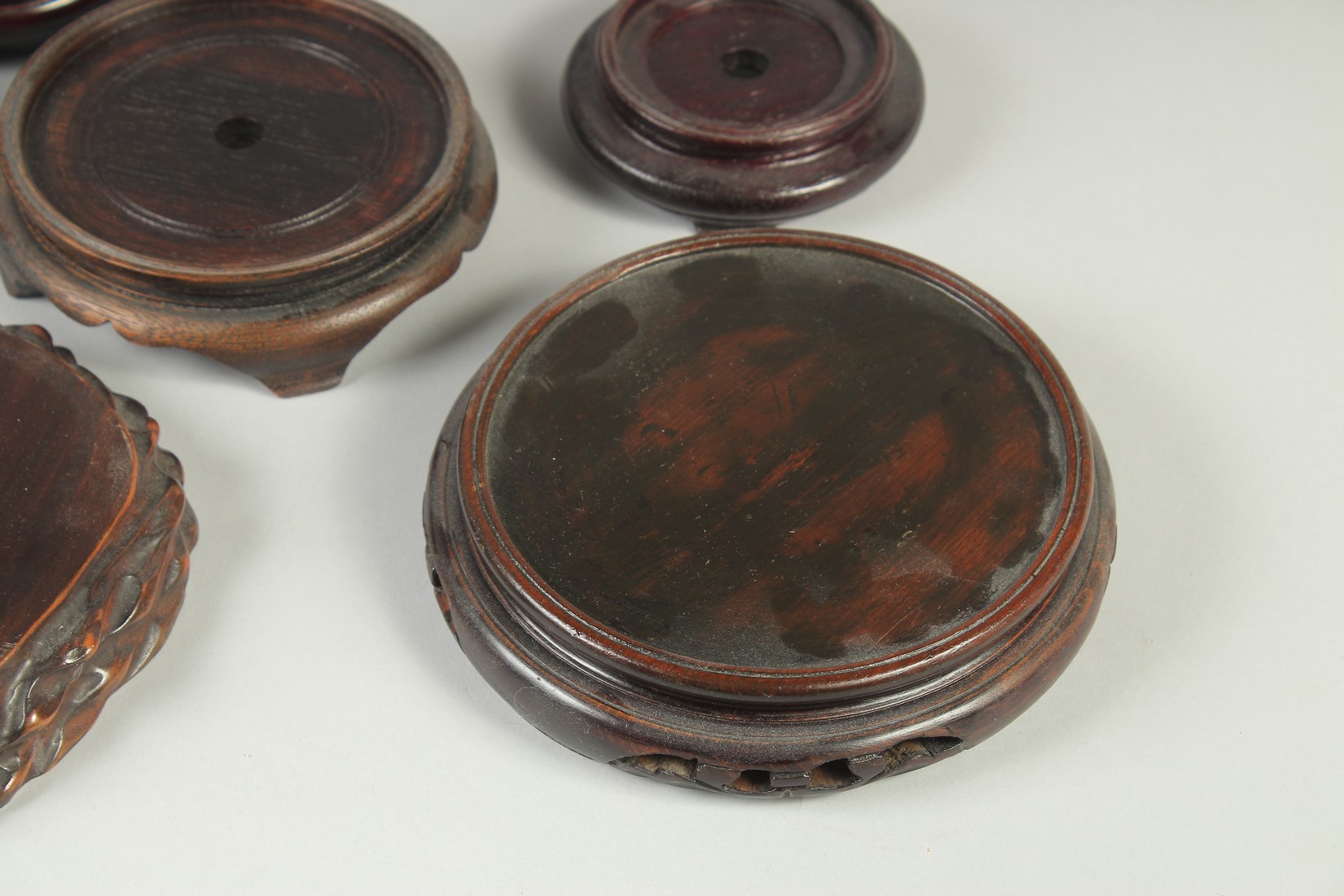 A COLLECTION OF EIGHT CHINESE HARDWOOD STANDS, various sizes, largest 17.5cm diameter. - Image 4 of 7