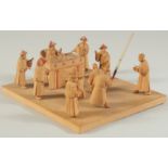 A LATE 19TH CENTURY CHINESE CARVED WOOD FIGURAL DIORAMA: PUNISHMENT SCENE, mounted to later base,