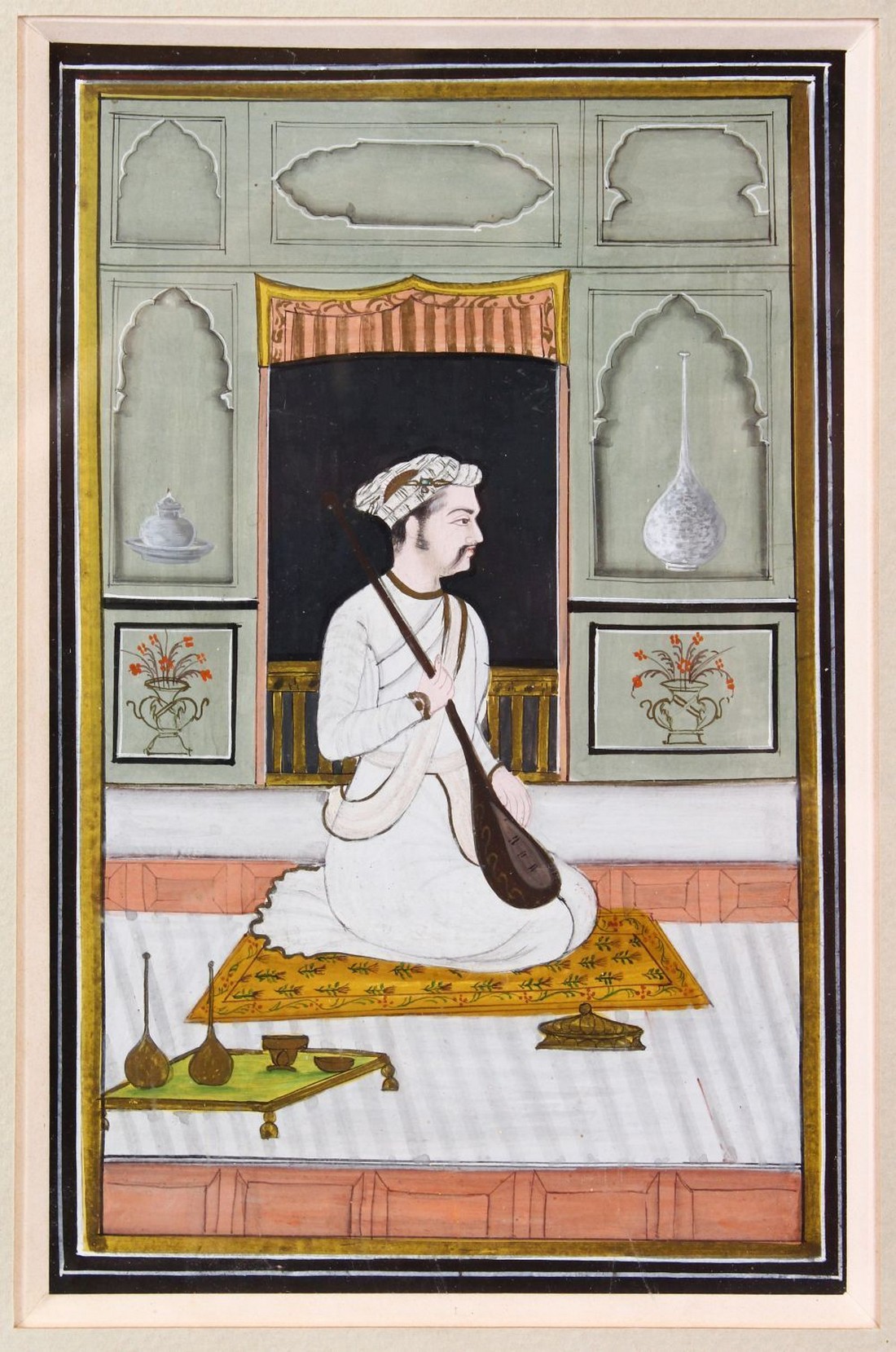 AN INDIAN MINIATURE PAINTING depicting a seated prince holding a sitar, image size 18cm x 11cm.