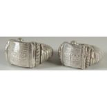 A PAIR OF ISLAMIC SILVER SLAVE BANGLES, with embossed and chased decoration, weight 590g.