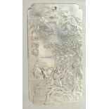 A CHINESE METAL RECTANGULAR PENDANT, depicting a scene with a figure flying on a bird above other