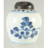 A VERY SMALL CHINESE BLUE AND WHITE PORCELAIN JAR AND HARDWOOD COVER, 7.5cm high.