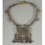 AN ISLAMIC SILVER AND GILT METAL MARRIAGE NECKLACE, with four Islamic coins attached.