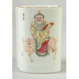 A SMALL CHINESE FAMILLE ROSE PORCELAIN BRUSH POT, painted with a figure seated upon a bull, the