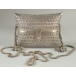 A FINE ISLAMIC SILVER PURSE, with finely pierced and engraved decoration, 15cm wide, weight 580g.