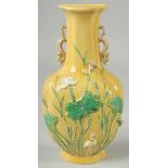 A CHINESE QING DYNASTY YELLOW GROUND SANCAI PORCELAIN WALL-POCKET VASE, with fine moulded chilong