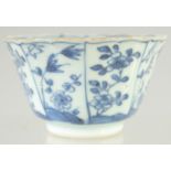 A CHINESE KANGXI BLUE AND WHITE PORCELAIN TEA BOWL, painted with panels of flora, interior with