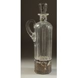 A DUTCH GLASS LIQUER DECANTER AND STOPPER with carrying handle and silver top and base. 11.5ins