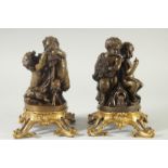 A GOOD PAIR OF BRONZE AND ORMOLU CUPID GROUPS each with two cupids, on ormolu bases. 9.5ins high.