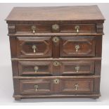 AN 18TH CENTURY OAK CHEST OF DRAWERS comprising four long drawers, each with geometric mouldings, on