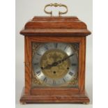 FRANZ HEMIE. AN OAK CASED BRACKET CLOCK with Westminster chime, brass dial, silvered chapter ring