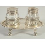 A GOOD EARLY GEORGE III TWO BOTTLED INKSTAND with pierced bottle holders, supported on four claw and