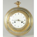 AN FRENCH BRASS CIRCULAR SEDAN CLOCK with enamel dial, with replacement battery works.