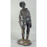 A BRONZE STANDING FIGURE OF A COWBOY. 18ins high.