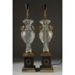 A PAIR OF BRONZE AND CUT GLASS LAMPS on square bases. 25ins high.