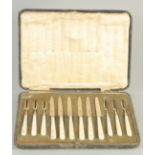 A CASED SET OF SIX MOTHER OR PEARL HANDLED KNIVES AND FORKS. Sheffield 1925.